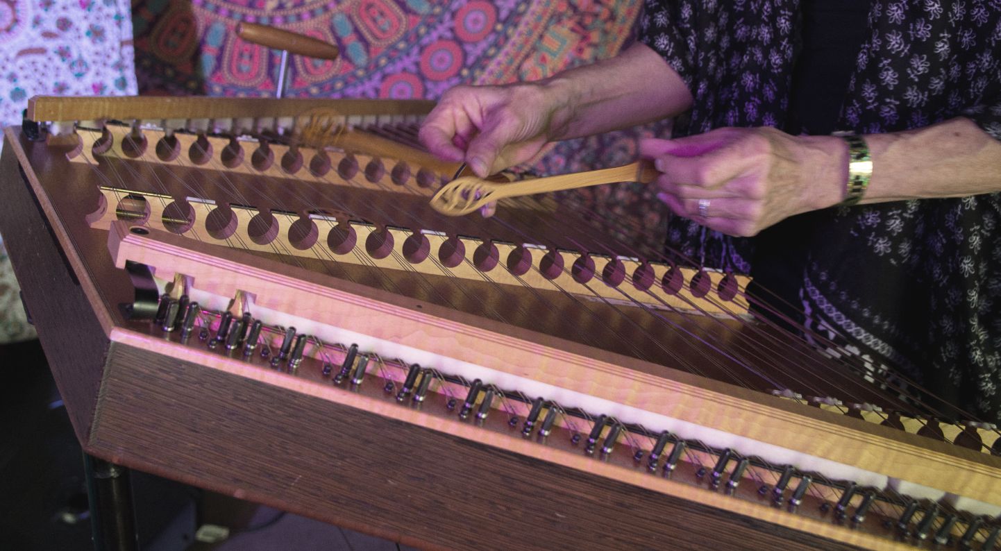A close up of the Hammer Dulcimer being played